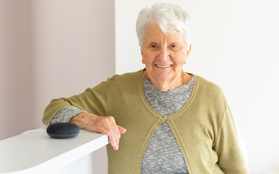 Woman standing next to Google Home Mini