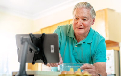 Man participating in cooking class on Virtual Social Centre