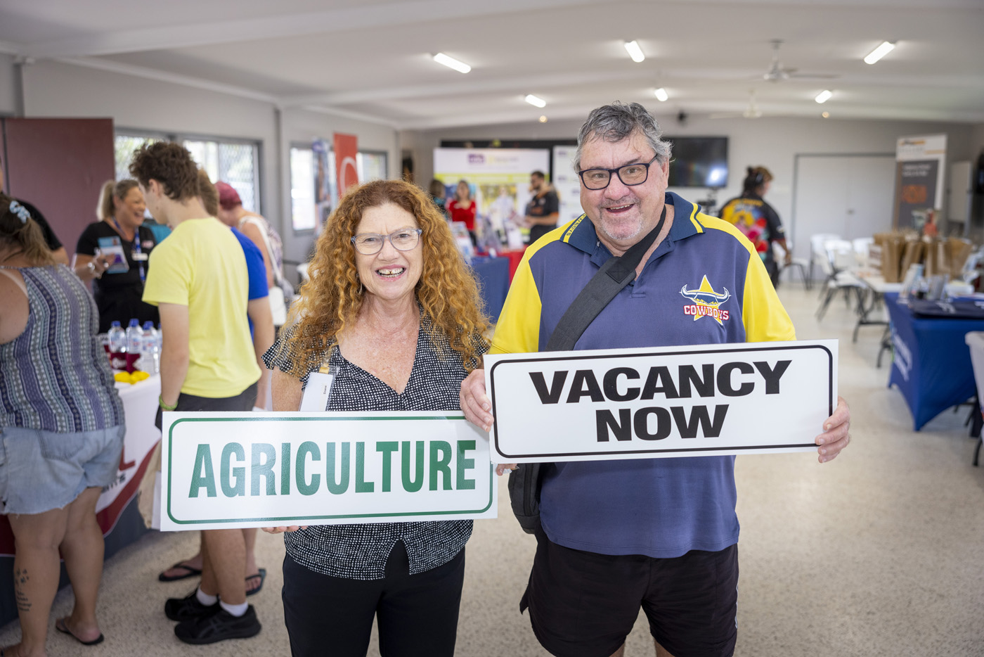 Lady and man holding up signs – Agriculture and Vacancy Now