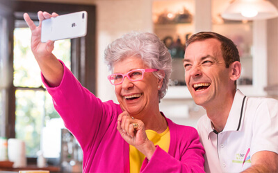 Woman taking a photo with technology support officer