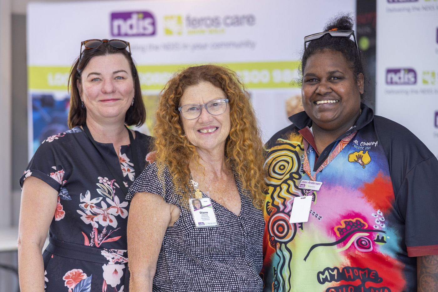 Three Feros Care team members facing camera smiling.